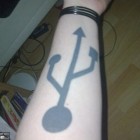 usb symbol arm tattoo 140x140 Super Mario Tattoos, Disease Plush Toys, iPhone Virus Solution [Walyou Roundup]