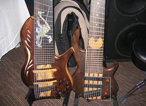 Imagine a bass Pacman guitar with wooden inlay of your favorite video games 